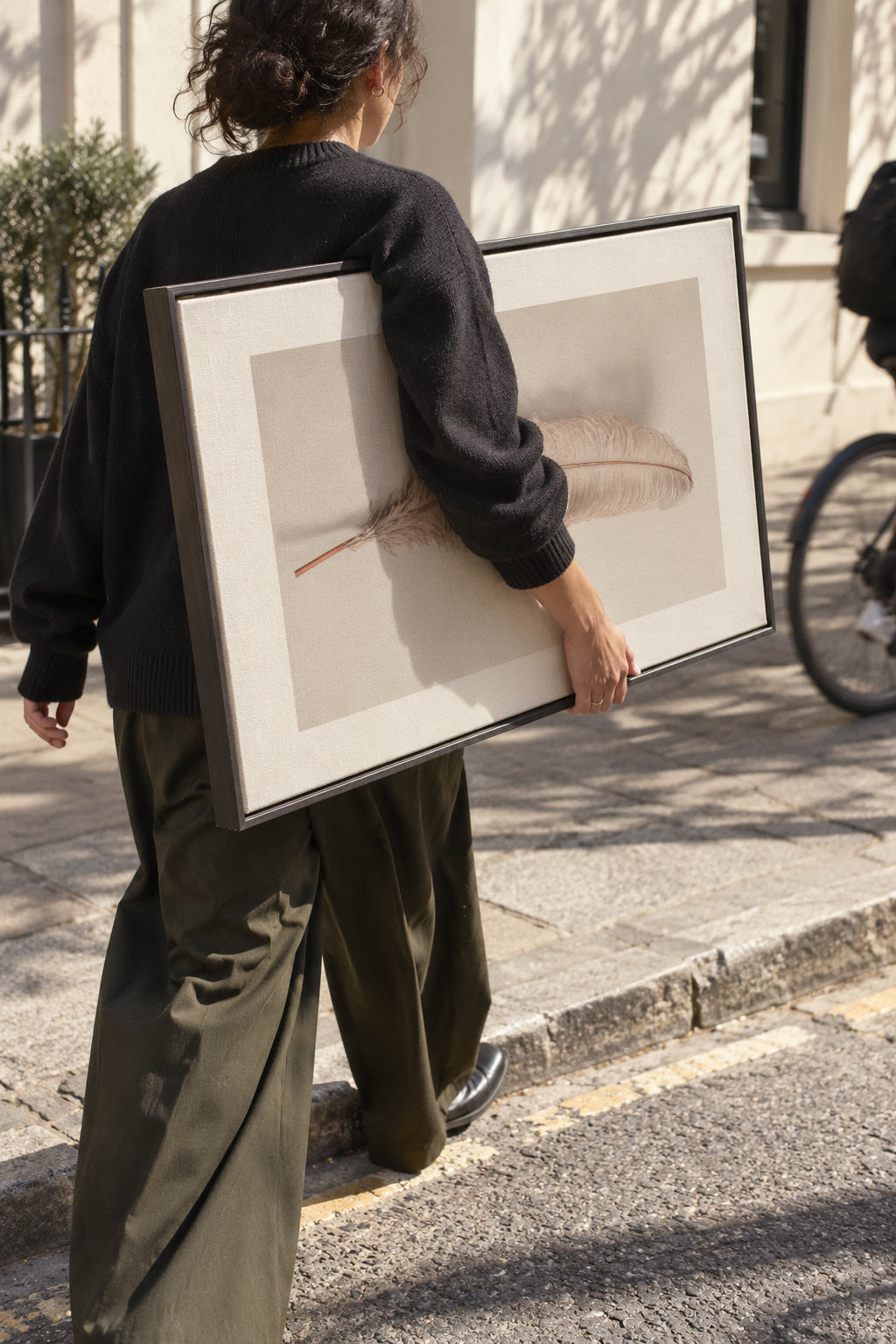 Feather II - Framed canvas in an interior