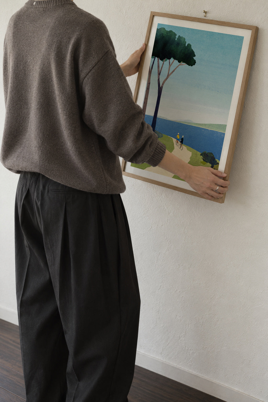 Cycling by the sea - Framed poster in an interior