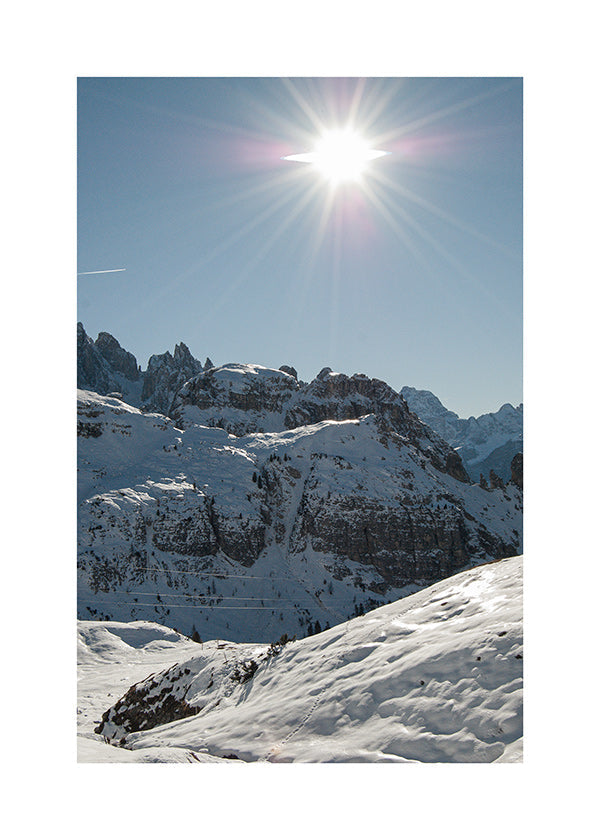 Küstenlandschaft: verschneite Gipfel mit strahlender Sonne